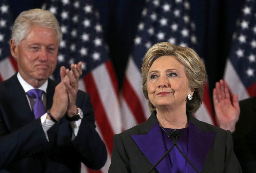 Democratic presidential candidate Hillary Clinton, with her husband, former U.S. President Bill Clinton, (L), receives applause at her concession speech to President-elect Donald Trump in New York, U. ...