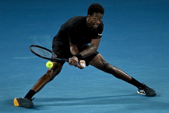 epa09707836 Gael Monfils of France plays a shot during his Men?s singles quarterfinal match against Matteo Berrettini of Italy at the Australian Open Grand Slam tennis tournament at Melbourne Park, in ...