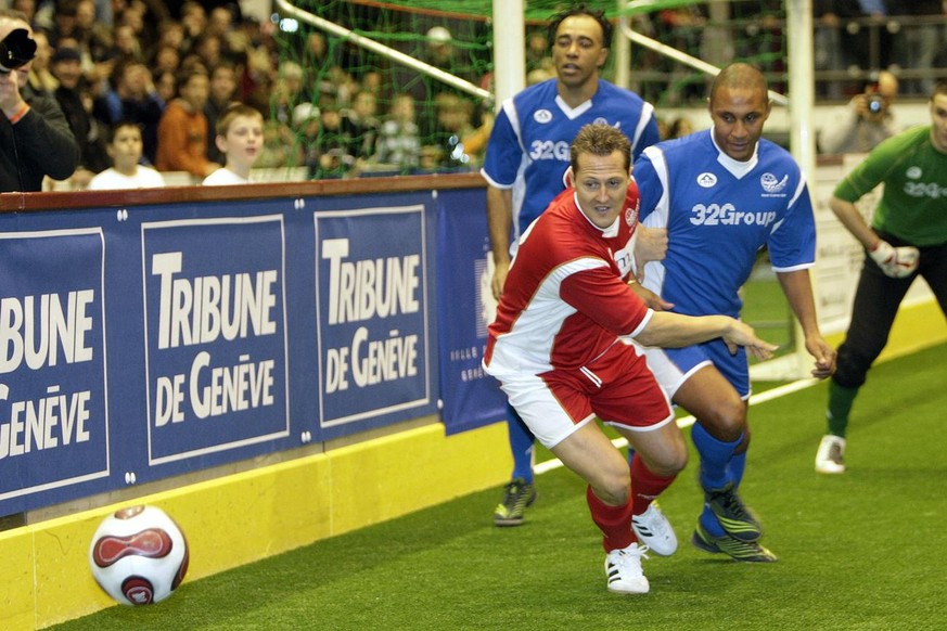 Former F1 pilote and seven times world champion Michal Schumacher, left, fights the ball with French players Franck Silvestre, right, and Patrice Loko, back, during a friendly game between former play ...