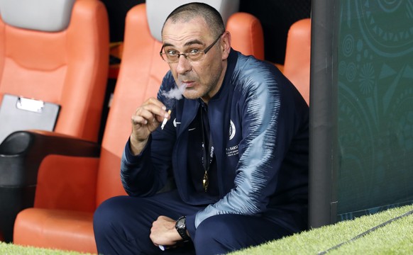 Chelsea head coach Maurizio Sarri smokes a cigaret on the bench after winning the Europa League Final soccer match between Chelsea and Arsenal at the Olympic stadium in Baku, Azerbaijan, Thursday, May ...