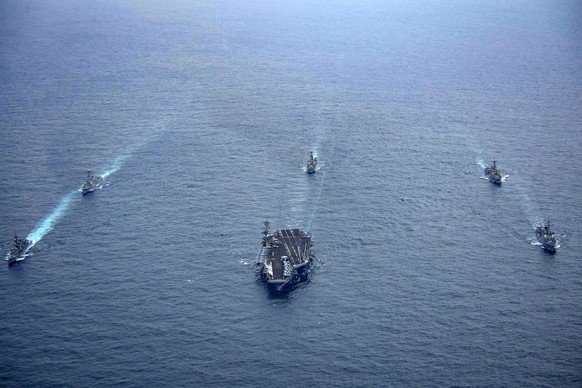 epa11274245 A handout photo made available by the South Korean Navy on 12 April 2024 shows the South Korean Aegis-equipped destroyer Seoae Ryu Seong-ryong, the nuclear-powered aircraft carrier USS The ...