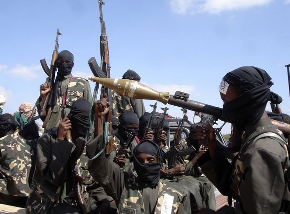 FILE - Armed al-Shabab fighters ride on pickup trucks as they prepare to travel into the city, just outside the capital Mogadishu, in Somalia on Dec. 8, 2008. Somali authorities said Monday, Oct. 3, 2 ...