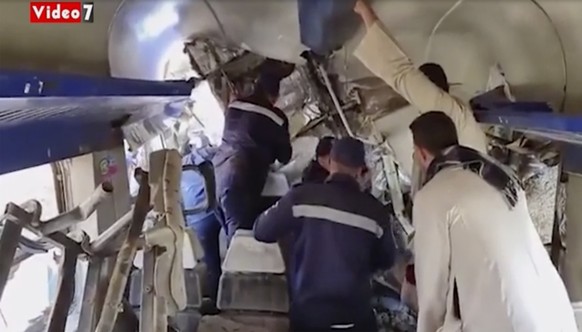 This image provided by Youm7 shows crowds of people inside a mangled train carriage at the scene of a train accident in southern Egypt, Friday, March 26, 2021. Two trains collided apparently after som ...