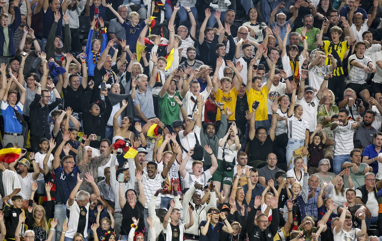 epa10857269 German fans cheer during the international friendly soccer match between Germany and France in Dortmund, Germany, 12 September 2023. EPA/CHRISTOPHER NEUNDORF