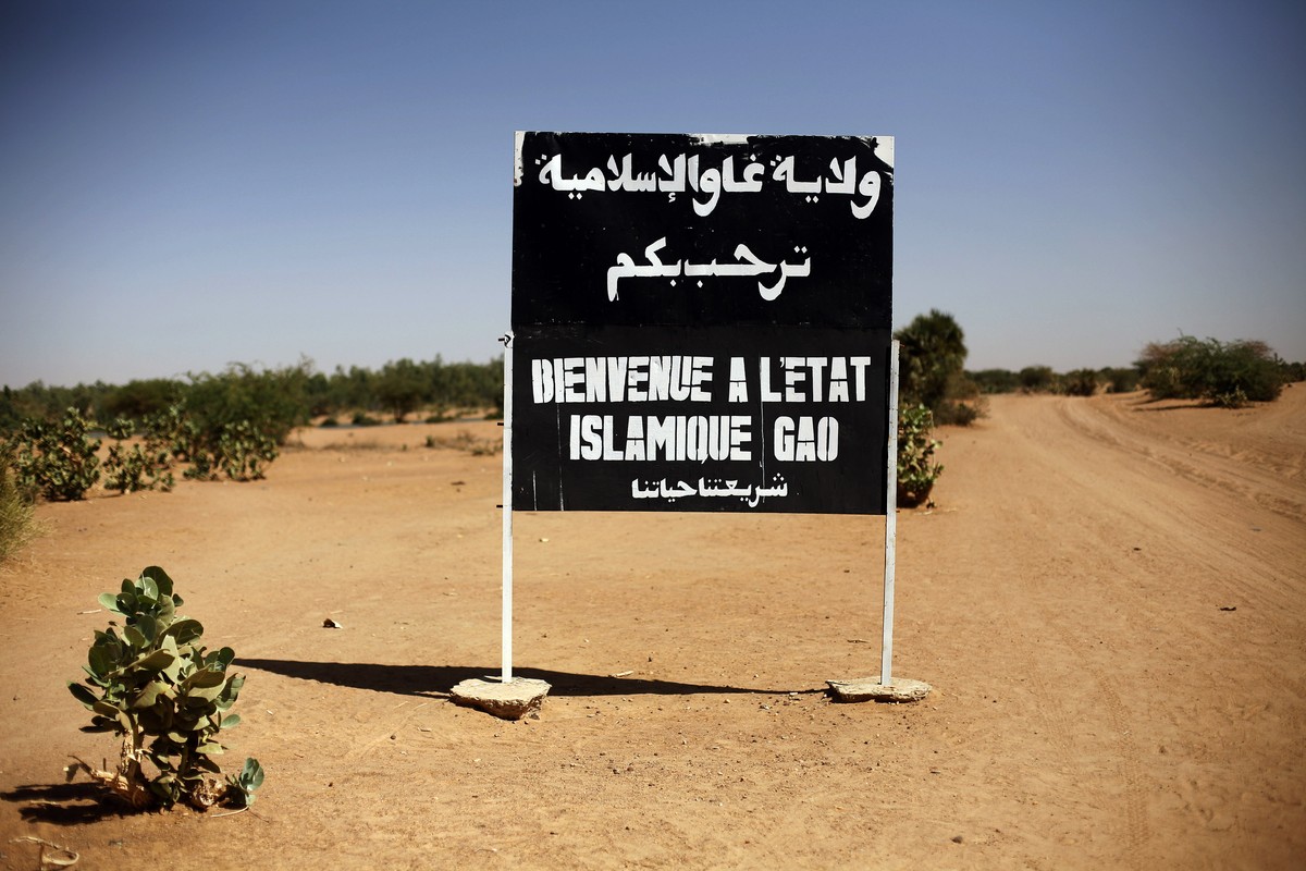 FILE - A sign on the northern road exiting in Gao, Northern Mali, reads "welcome to the islamic state of Gao on Jan. 30, 2013. Islamic State extremists have almost doubled the territory they cont ...