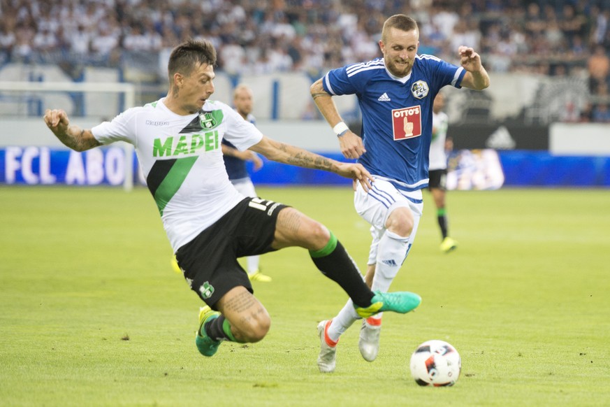Francesco Acerbi, left, of Sassuolo, and Jakob Jantscher, right, of Luzern, in action during the UEFA Europa League third qualifying round first leg soccer match between Swiss Club FC Luzern and Itali ...