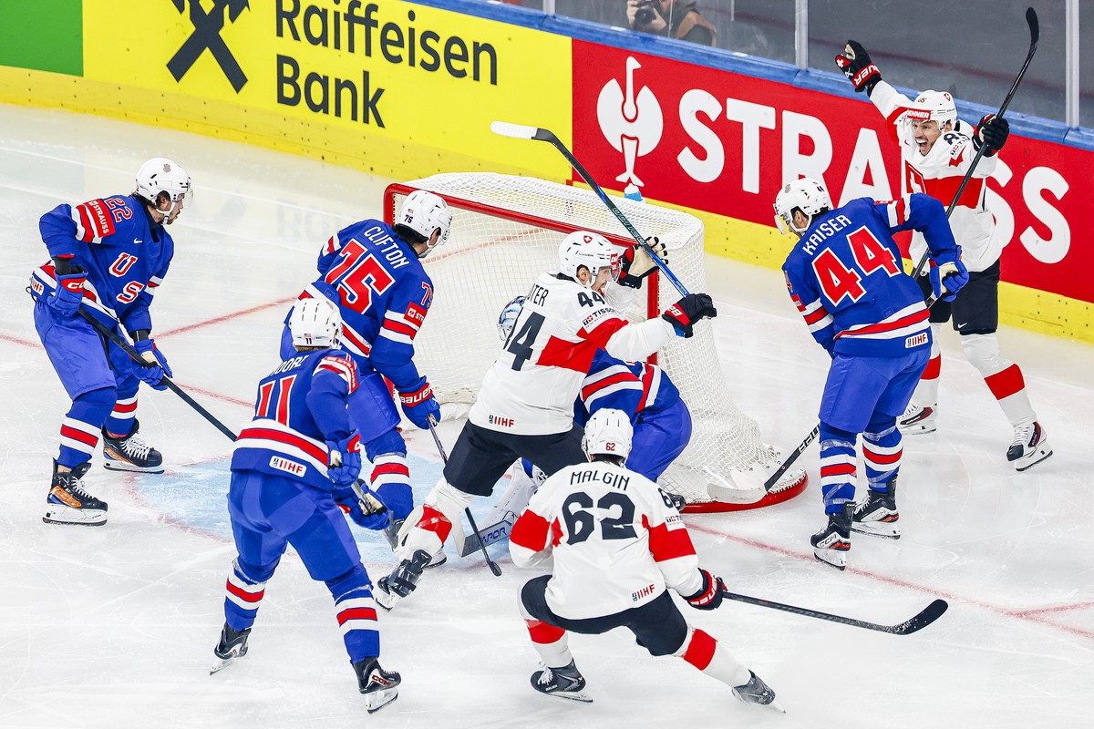 Switzerland's Pius Suter, center #44, reacts after scoring his teams first goal during the 2026 IIHF Men's Ice Hockey World Championship preliminary round group A game between United States  ...