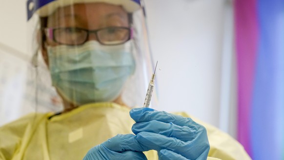 FILE - A physician assistant prepares a syringe with the monkeypox vaccine for a patient during a vaccination clinic Friday, Aug. 19, 2022, in New York. The disease