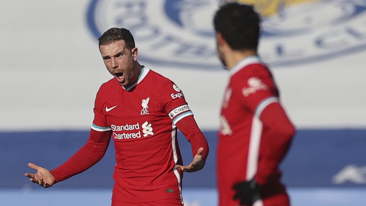 Liverpool's Jordan Henderson, left, shouts out during the English Premier League soccer match between Leicester City and Liverpool at the King Power Stadium in Leicester, England, Saturday, Feb. 13, 2 ...