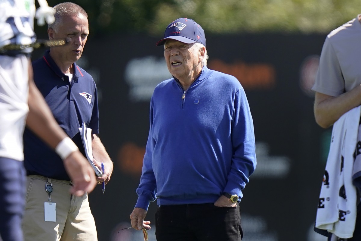 New England Patriots owner Robert Kraft, center, stands on the field during an NFL football practice, Wednesday, Aug. 2, 2023, in Foxborough, Mass. (AP Photo/Steven Senne)