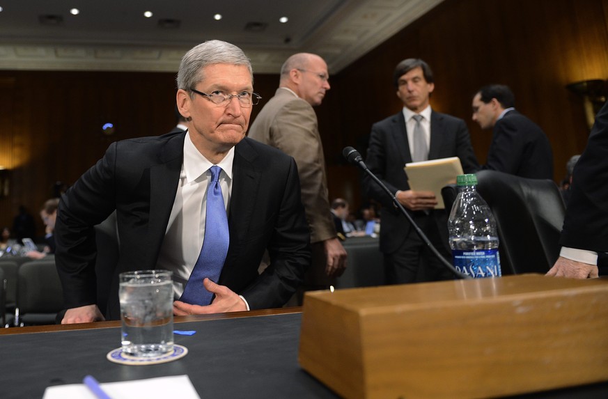 epa05171707 (FILE) A file picture dated 21 May 2013 shows Apple Inc. Chief Executive Tim Cook preparing to testify before the Senate Homeland Security and Governmental Affairs Committee's Investigatio ...