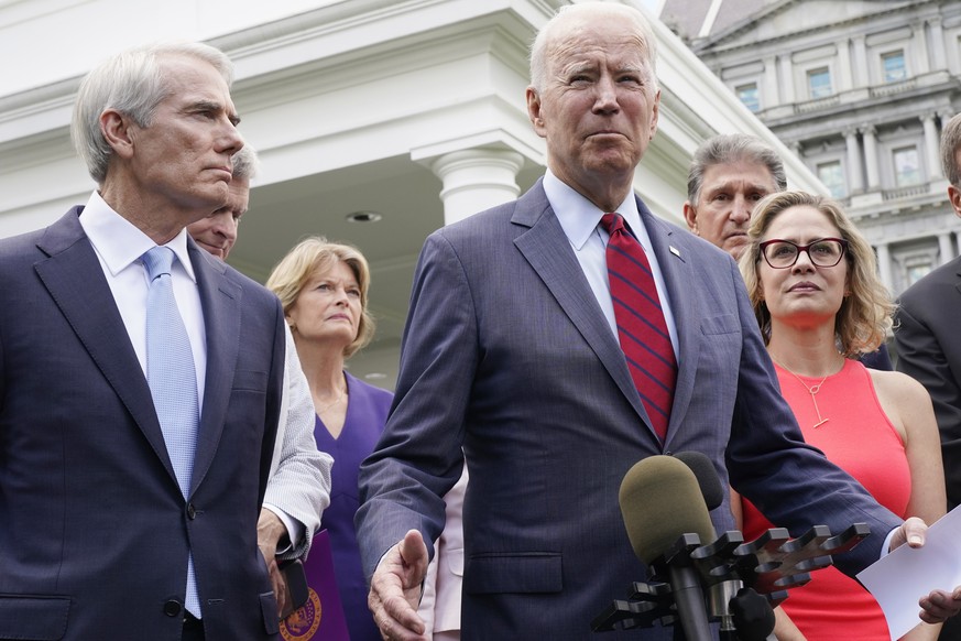 President Joe Biden, with a bipartisan group of senators, speaks Thursday June 24, 2021, outside the White House in Washington. Biden invited members of the group of 21 Republican and Democratic senat ...