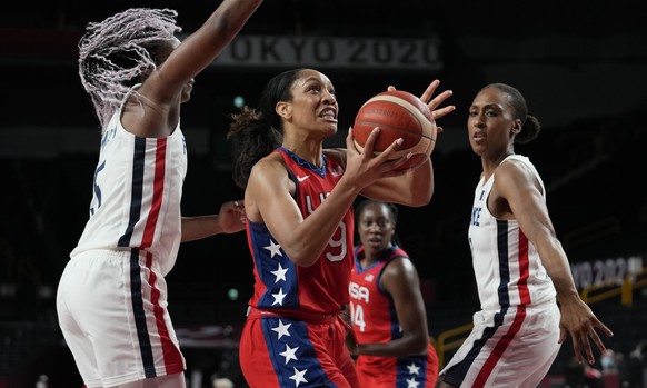 United States&#039; A&#039;Ja Wilson (9), center, drives past France&#039;s Endene Miyem (5), left, during women&#039;s basketball preliminary round game at the 2020 Summer Olympics, Monday, Aug. 2, 2 ...