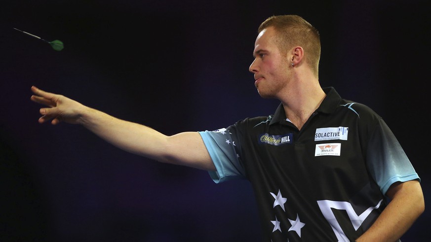 Max Hopp throws during his match against Danny Noppert during the World Darts Championships at Alexandra Palace in London, Saturday Dec. 15, 2018. (Mark Kerton/PA via AP)