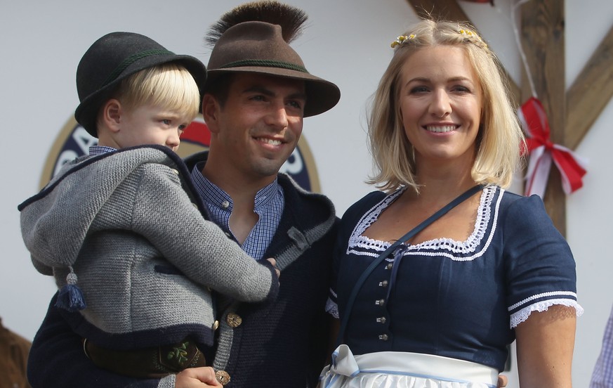 MUNICH, GERMANY - SEPTEMBER 30: Philipp Lahm of FC Bayern Muenchen, his wife Claudia and son Julian attend the Oktoberfest beer festival 2015 at Theresienwiese on September 30, 2015 in Munich, Germany ...