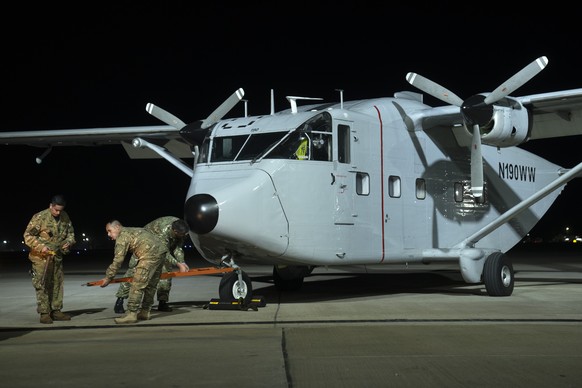 Airmen get ready to move one of the planes used in the &quot;death flights,&quot; when detainees were tossed out into the sea during Argentina&#039;s last military dictatorship, on the tarmac of the J ...