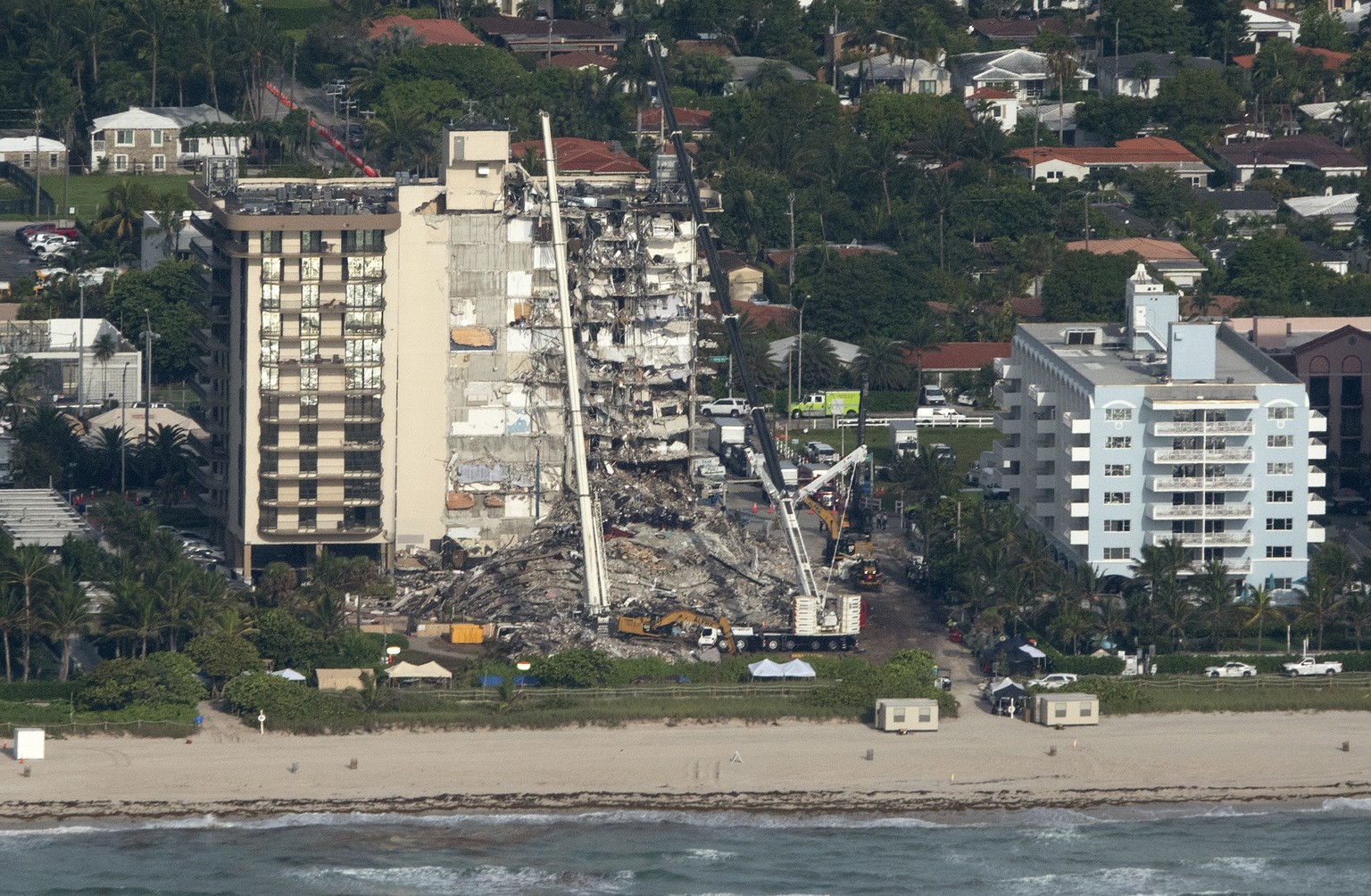 epa09305196 An aerial view of the partial collapsed 12-story condominium building in Surfside, Florida, USA, 27 June 2021. The 12-story beachfront condominium building in the Miami suburb of Surfside, ...