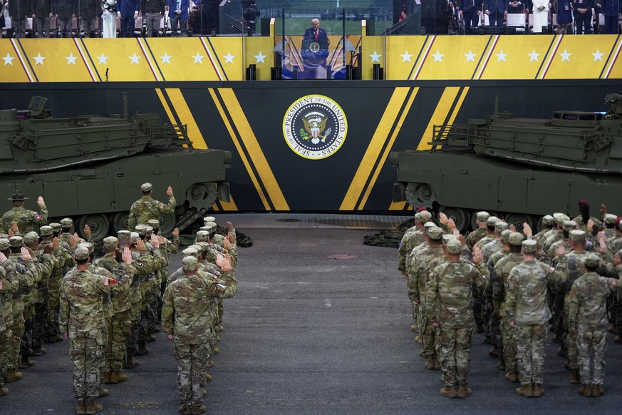 President Donald Trump participates in a reenlistment ceremony for Army soldiers during a military parade commemorating the Army's 250th anniversary Saturday, June 14, 2025, in Washington. (AP Ph ...