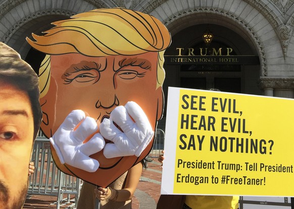 Members of Amnesty International demonstrate outside Trump International Hotel in Washington, Thursday, June 15, 2017. They were urging the administration of President Donald Trump administration to e ...