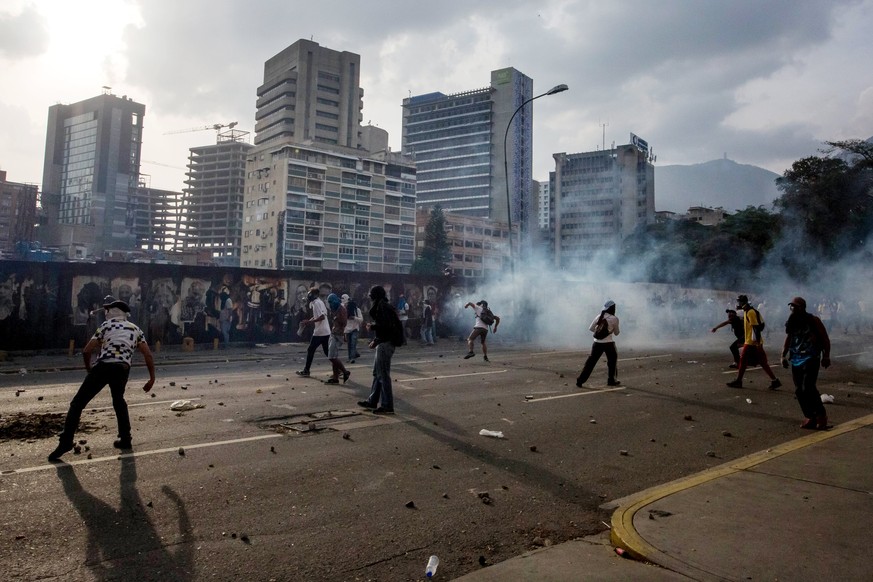 epa05916116 A demonstrators holds a Molotov cocktail during clashes with police during protests in Caracas, Venezuela, 19 April 2017. Police, using tear gas, dispersed protesters in the center of Cara ...