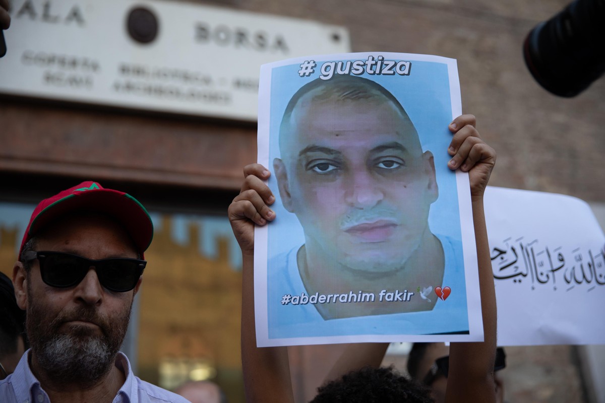 epa13123809 People hold a picture during a demonstration calling for justice for Abderrahim Fakir, a Moroccan man who died while being restrained by police during an arrest, in Bologna, Italy, 20 July ...