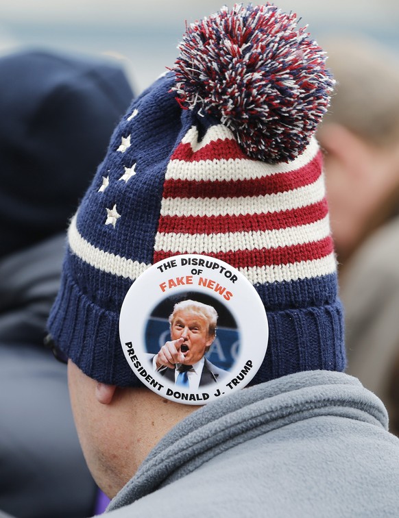 epa05735674 People listen as President Donald J. Trump delivers his Inaugural address after taking the oath of office as the 45th President of the United States in Washington, DC, USA, 20 January 2017 ...