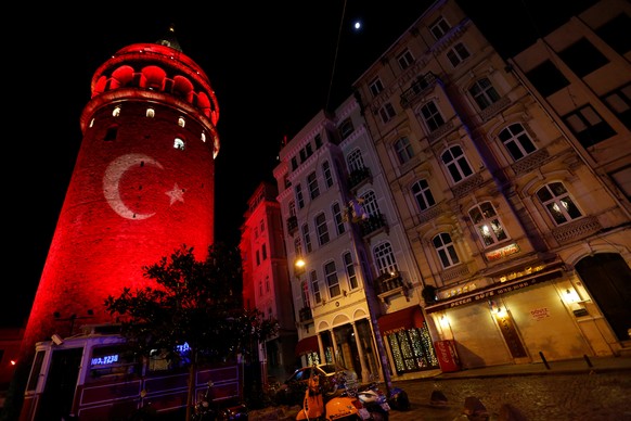 A Turkish flag is projected on the historical Galata Tower in tribute to the victims of Saturday's blasts, in Istanbul, Turkey, early December 12, 2016. REUTERS/Murad Sezer