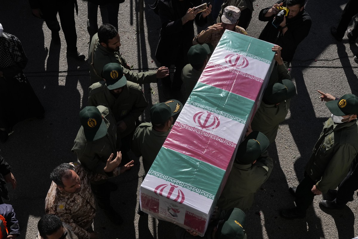 Revolutionary Guard members carry the flag-draped coffin of a victim of Wednesday's bomb explosion, during the victims funeral ceremony in the city of Kerman about 510 miles (820 kms) southeast o ...