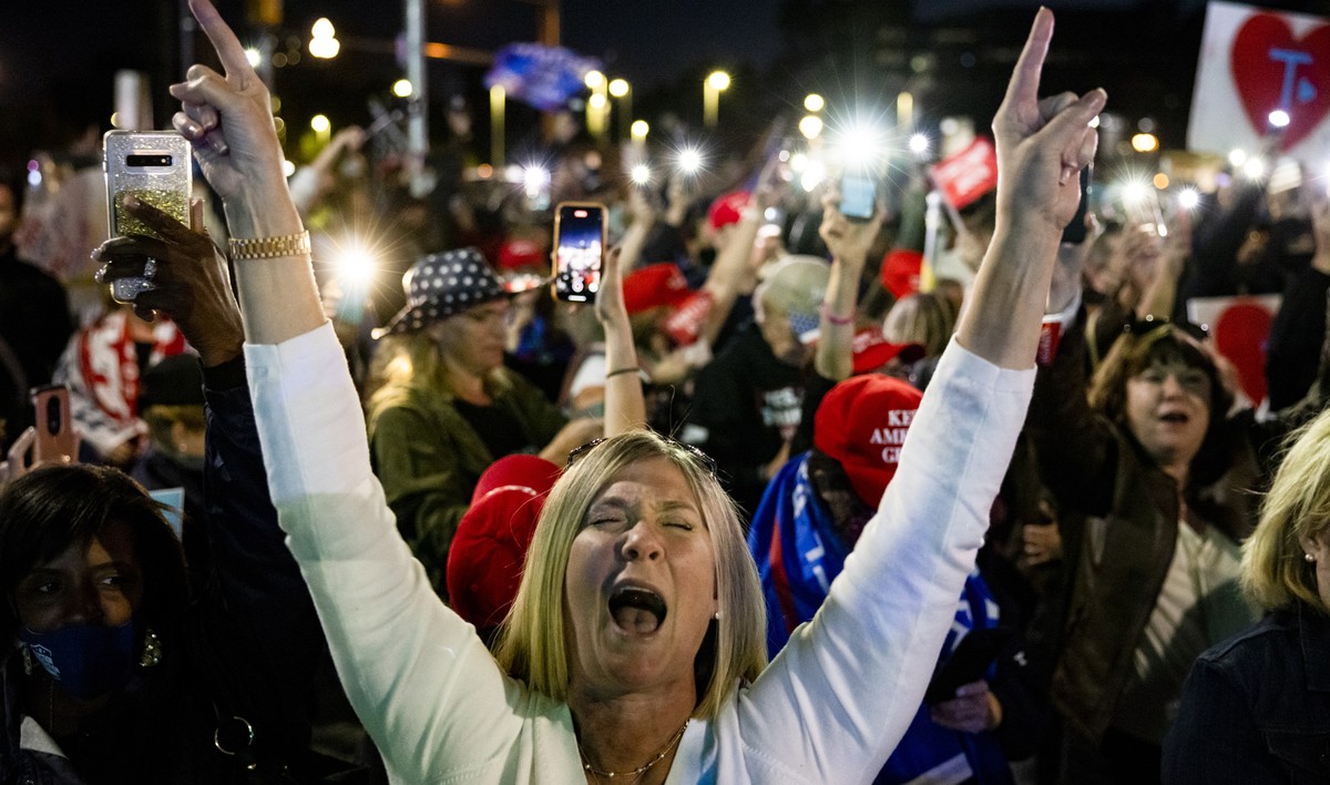 epaselect epa08718917 Supporters of US President Donald Trump chant 'Four More Years' as they gather outside the Walter Reed National Military Hospital where the president was taken after te ...