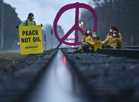 Early this morning, activists from Greenpeace block a rail track leading to the oil refinery in Schwedt, Germany, Tuesday, March 15, 2022. With this action, Greenpeace protests against fossil imports  ...