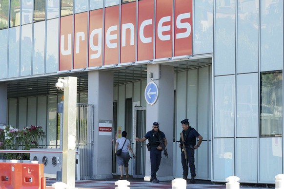 Armed French police secure the entrance to the Pasteur Hospital the day after a truck ran into a crowd at high speed killing scores and injuring more who were celebrating the Bastille Day national hol ...