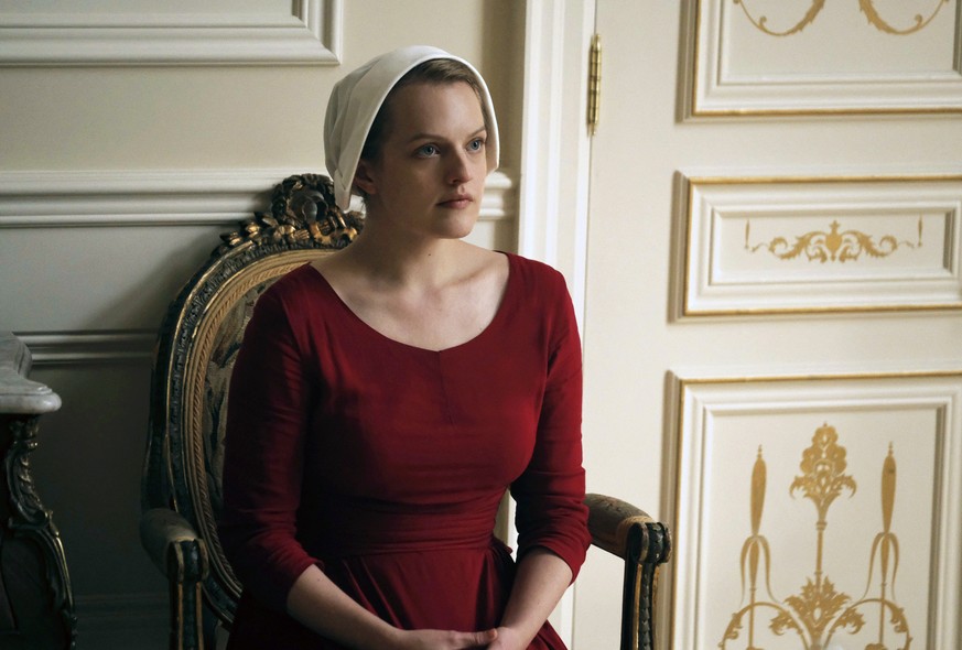 This image released by Hulu shows Elisabeth Moss as Offred in a scene from, &quot;The Handmaid&#039;s Tale,&quot; premiering Wednesday on Hulu with three episodes. The remaining seven hours will be re ...