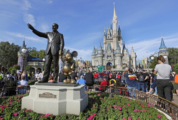 FILE - A statue of Walt Disney and Micky Mouse stands in front of the Cinderella Castle at the Magic Kingdom at Walt Disney World in Lake Buena Vista, Fla., Jan. 9, 2019. Florida Gov. Ron DeSantis? ov ...
