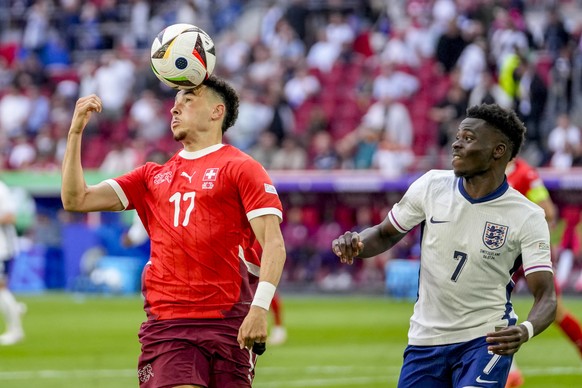Switzerland&#039;s Ruben Vargas, left, and England&#039;s Bukayo Saka challenge for the ball during a quarterfinal match between England and Switzerland at the Euro 2024 soccer tournament in Duesseldo ...