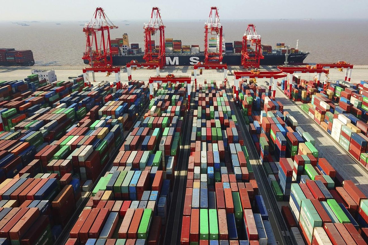 In this April 10, 2018, photo, a cargo ship is docked at the Yangshan container port in Shanghai, China. The Asian Development Bank said in a report Wednesday, April 11 the bank is forecasting that de ...