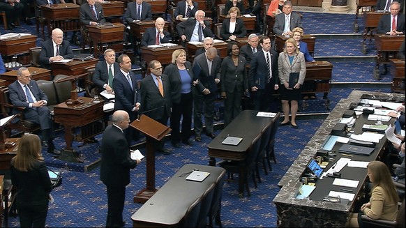 In this image from video, Senate Sergeant at Arms Michael Stenger leads the House impeachment managers into the Senate well as the impeachment trial against President Donald Trump begins in the Senate ...