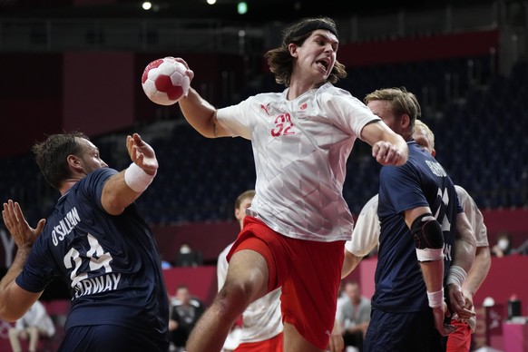 Denmark&#039;s Jacob Holm scores a goal during the men&#039;s quarterfinal handball match between Denmark and Norway at the 2020 Summer Olympics, Tuesday, Aug. 3, 2021, in Tokyo, Japan. (AP Photo/Serg ...