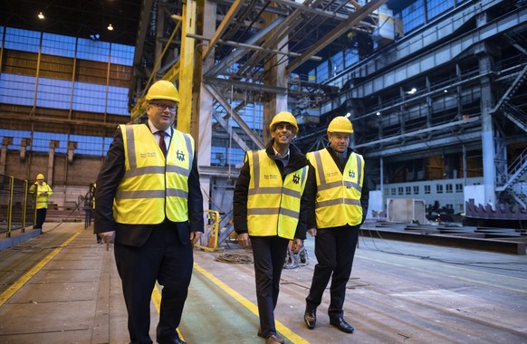 British Prime Minister Rishi Sunak, centre, visits the Harland & Wolff shipyard factory, accompanied by Northern Ireland Secretary of State Chris Heaton-Harris, right, and H&W CEO John Wood...