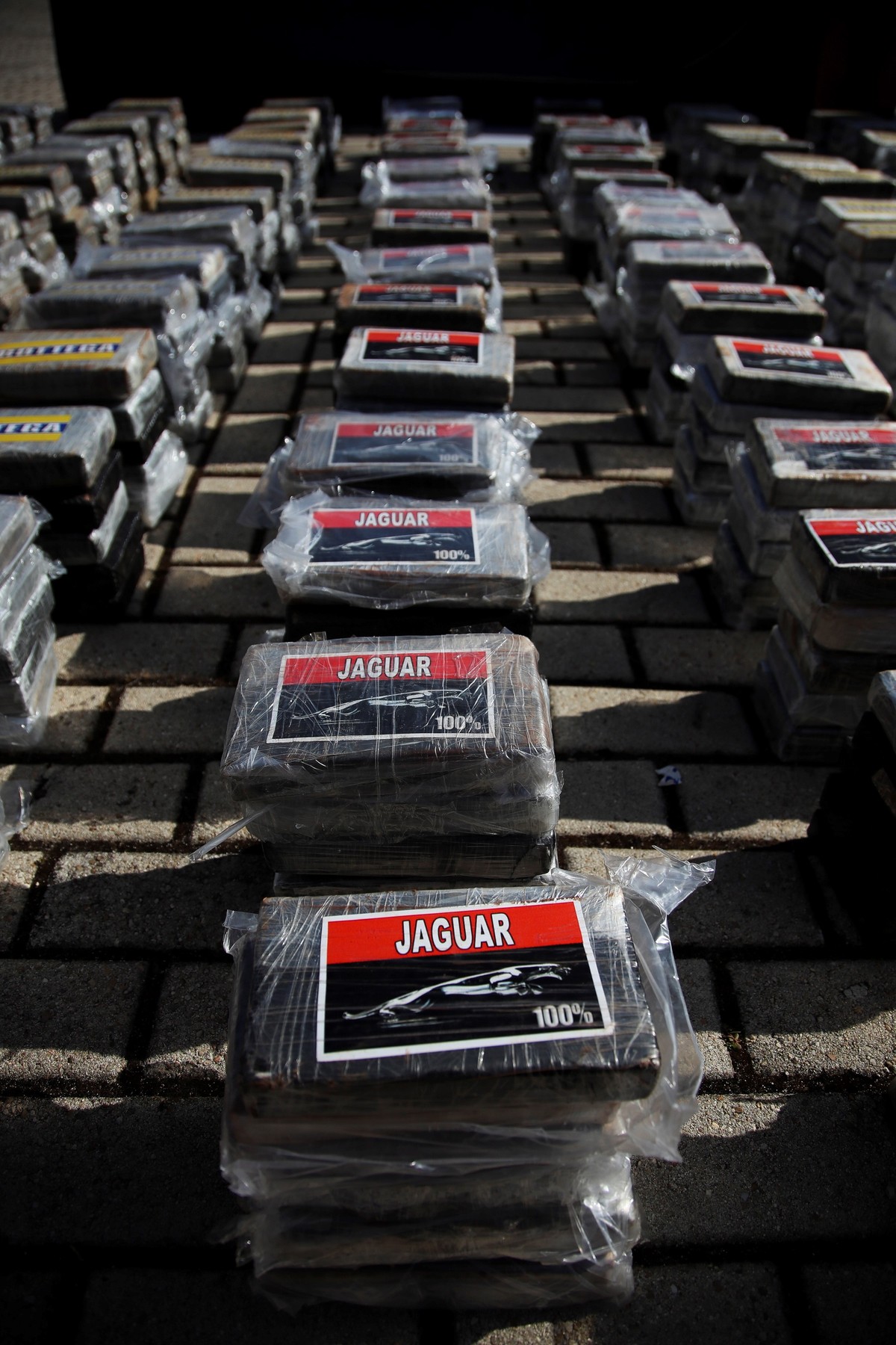 epa09491265 View of several bundles containing cocaine displayed during a press conference to inform on 'Musala' police operation at Spanish National Police headquarters in Madrid, Spain, 27 ...