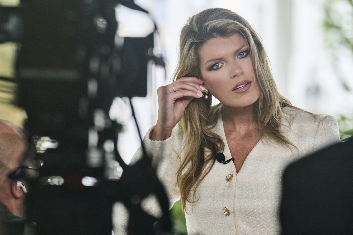 Lindsey Halligan, special assistant to the president, fixes an earring at the end of an interview outside of the White House, Wednesday, Aug. 20, 2025, in Washington. (AP Photo/Jacquelyn Martin)
Linds ...