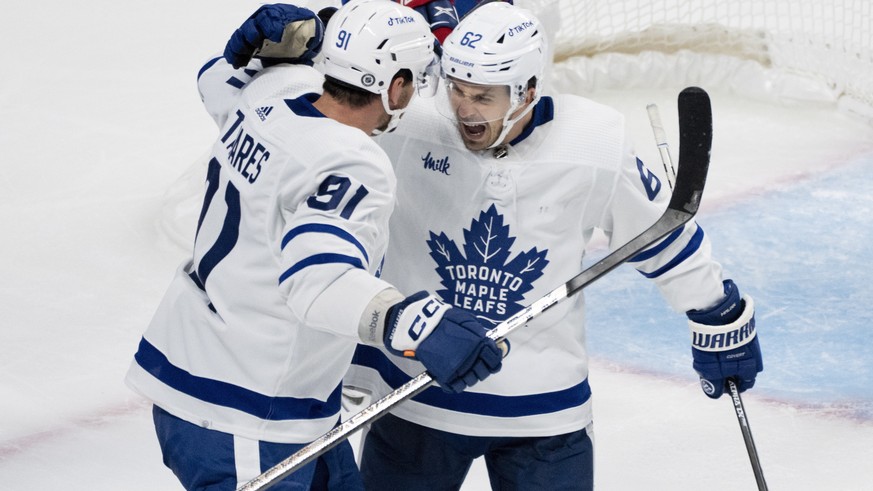 Toronto Maple Leafs&#039; Denis Malgin, right, celebrates his goal against the Montreal Canadiens with John Tavares during the second period of an NHL hockey game Wednesday, Oct. 12, 2022, in Montreal ...