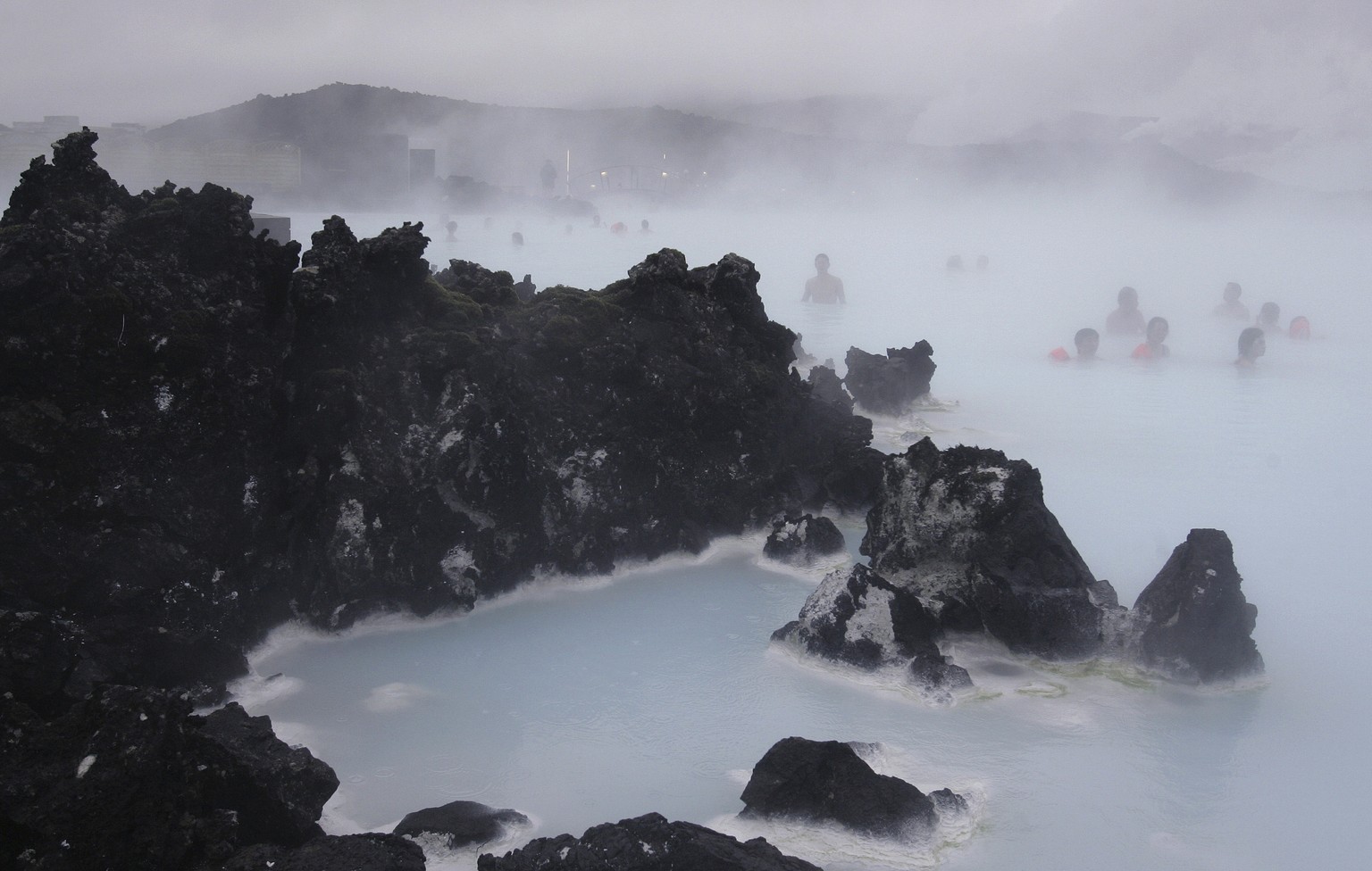 FILE- In this Feb. 21, 2006 file photo Tourists relax in the Blue Lagoon geothermal spa, Iceland on Feb. 21,2006. The geothermal spa Blue Lagoon has temporarily closed after a series of earthquakes ha ...