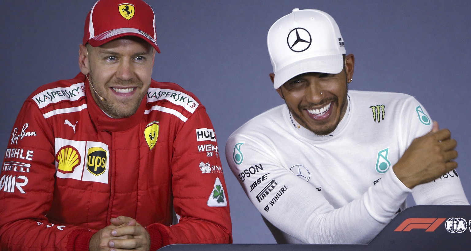 Mercedes driver Lewis Hamilton, right, of Britain, and Ferrari driver Sebastian Vettel of Germany laugh during a press conference following qualifying at the Australian Formula One Grand Prix in Melbo ...