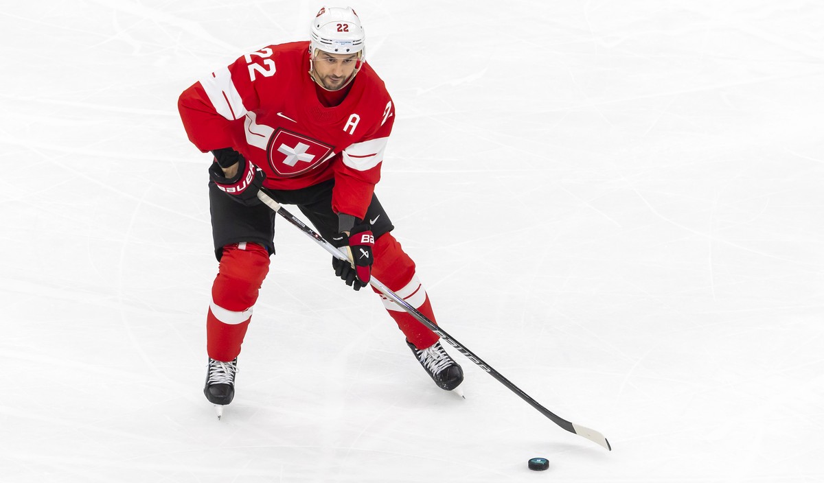 Switzerland's Nino Niederreiter controls the puck, during the men's group A preliminary round game between Switzerland and France at the 2026 Olympic Winter Games in Milan Santagiulia Ice Ho ...