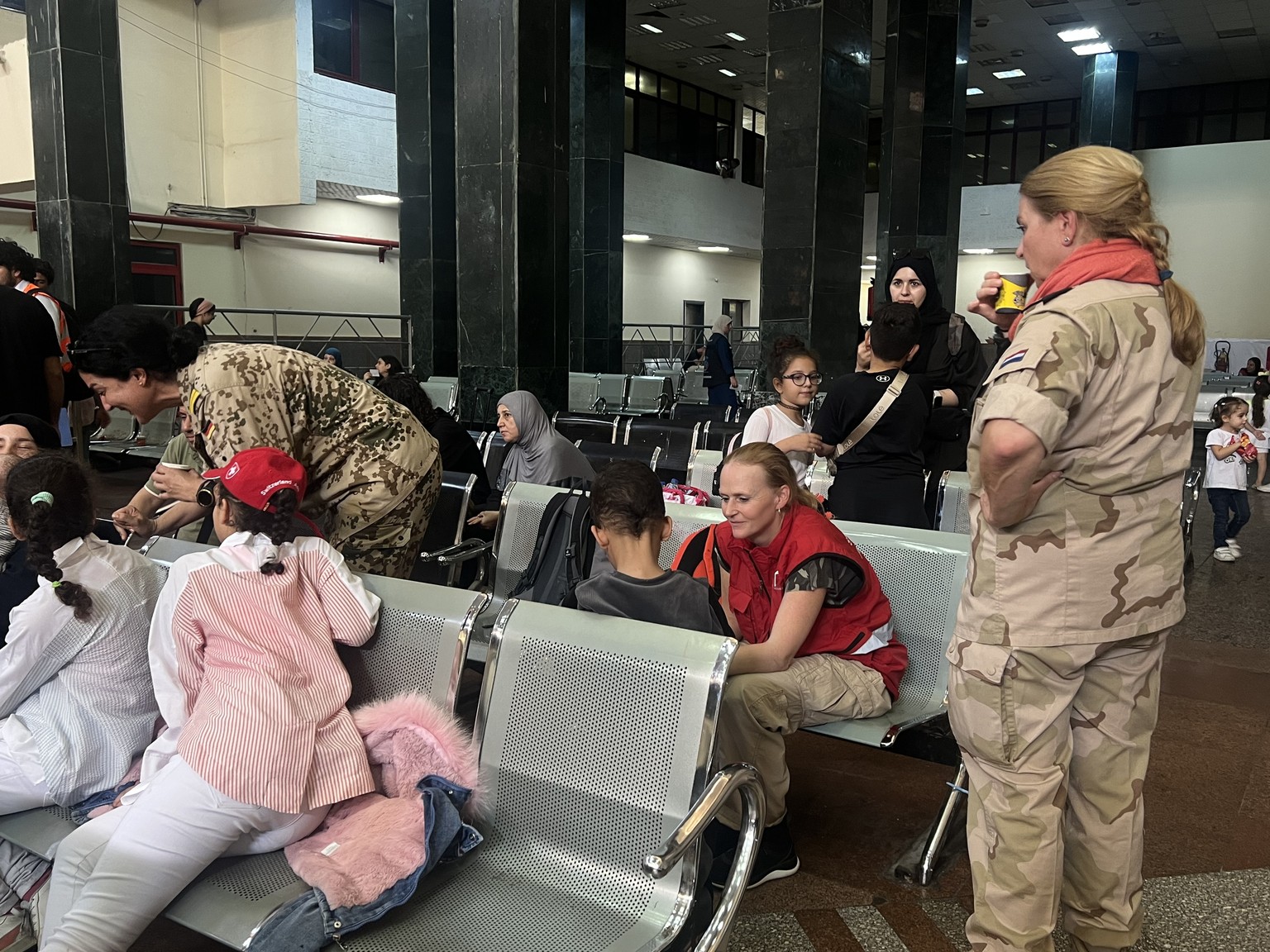 epa10954357 Several foreign nationals wait at the Egyptian side of the border after passing the Rafah border crossing between the Gaza Strip and Egypt, in Rafah, Egypt, 02 November 2023. As per the ag ...