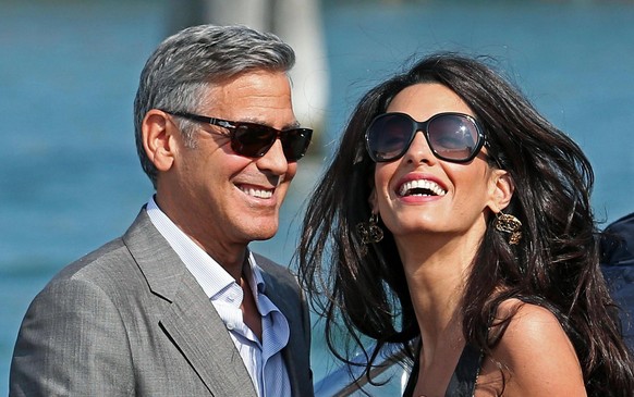 epa05782511 (FILE) - A file picture dated 26 September 2014 shows US actor George Clooney (L) and his fiance, Lebanese-British lawyer Amal Alamuddin (R) arrive in Venice, Italy. Media reports on 10 Fe ...