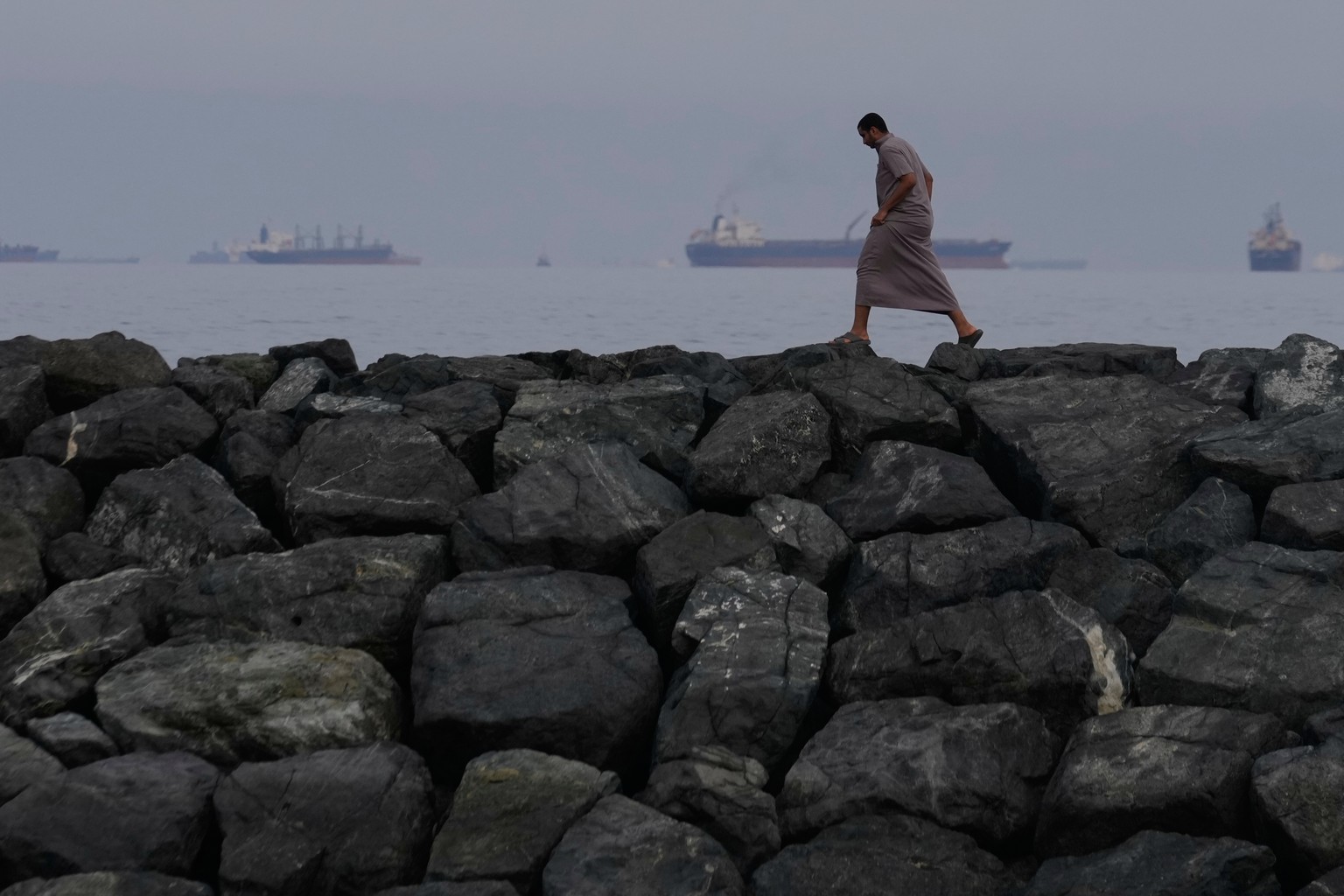 A man walks along the shore as oil tankers and cargo ships line up in the Strait of Hormuz, seen from Khor Fakkan, United Arab Emirates, Wednesday, March 11, 2026. (AP Photo/Altaf Qadri)
AP-Pictures-o ...
