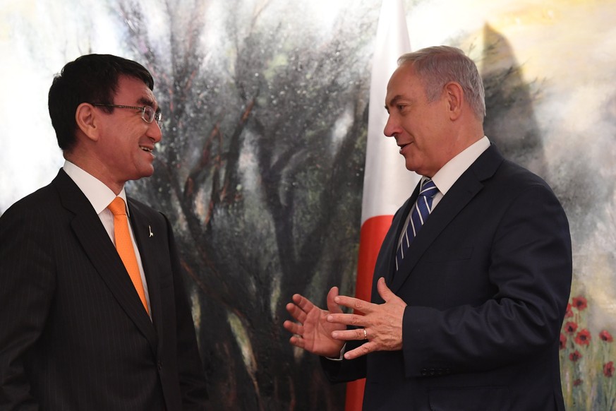 epa06405609 A handout photo made available by the Israeli Government Press Office (GPO) on 25 December 2017 shows Israel&#039;s Prime Minister Benjamin Netanyhau (R) speaking with Taro Kono (L), the M ...