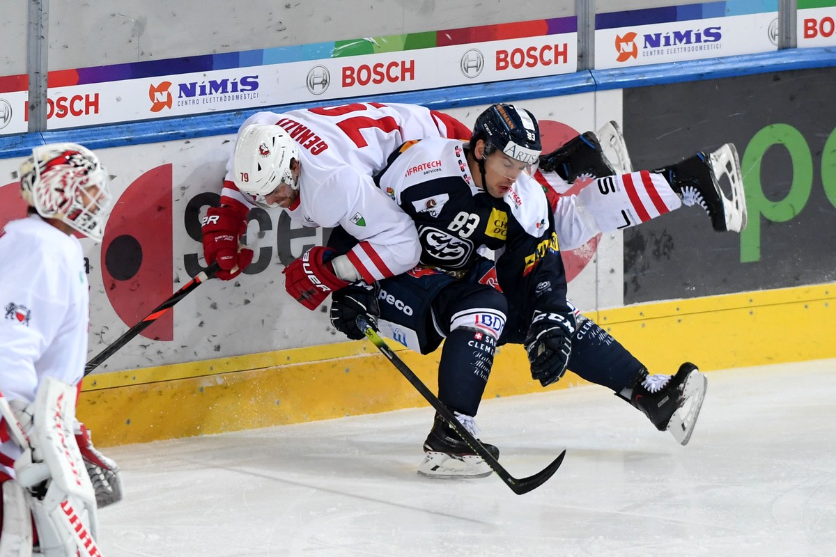 Ambri's player Scottie Upshall right fights for the puck with Lausanne's player Joel Genazzi left, during the preliminary round game of National League A (NLA) Swiss Championship 2019/20 bet ...