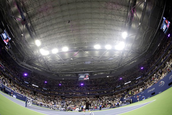 Roger Federer, of Switzerland, warms up for a match against Frances Tiafoe, of the United States, under the closed roof at Arthur Ashe Stadium at the U.S. Open tennis tournament, Tuesday, Aug. 29, 201 ...